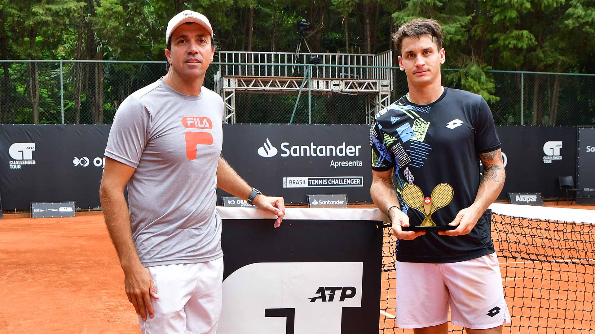 Camilo Ugo Carabelli and coach Carlos Berlocq after the Argentine won the Brasil Tennis Challenger.