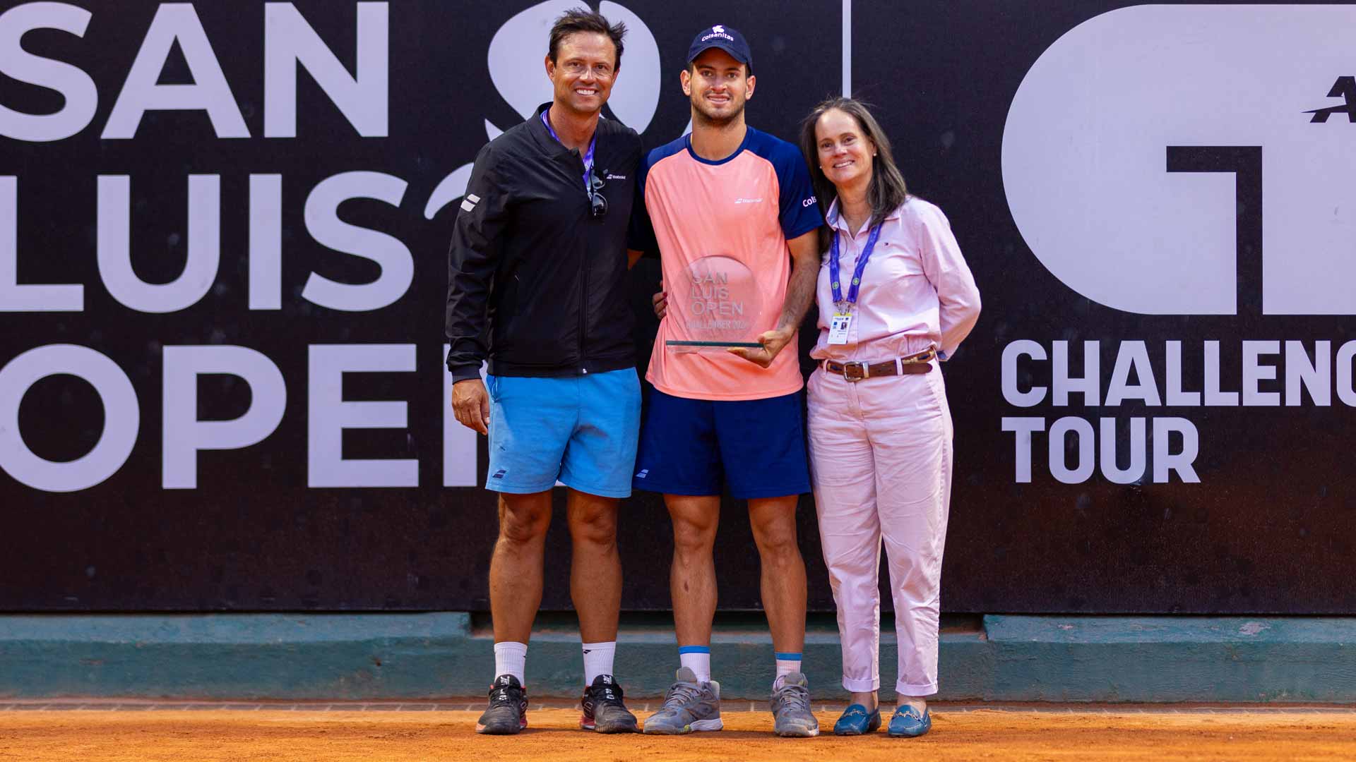 <a href='https://wwwx.atptour.com/en/players/nicolas-mejia/m0aw/overview'>Nicolas Mejia</a> poses with coach <a href='https://wwwx.atptour.com/en/players/juan-mateus/m726/overview'>Juan Mateus</a> and mother Helena.