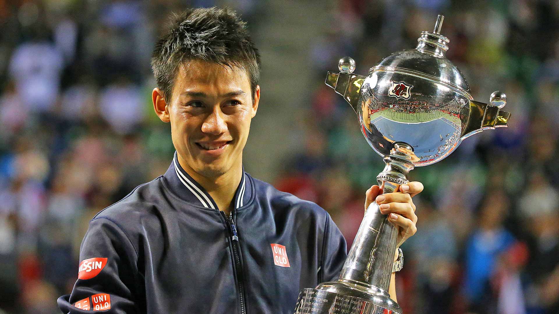 Kei Nishikori lifts the Tokyo trophy for the second time after defeating Milos Raonic in the 2014 final.